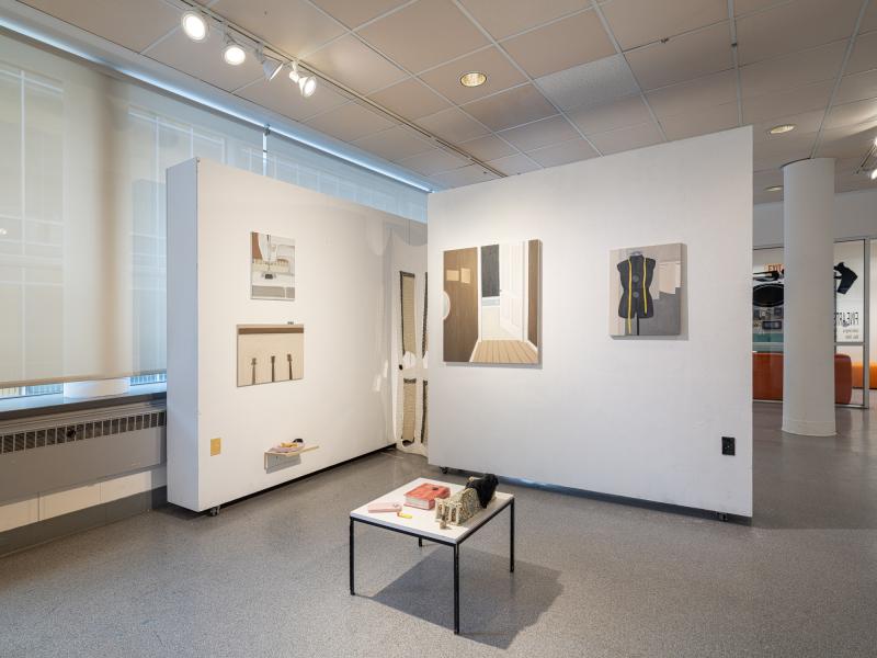 image of multiple paintings and a floor sculpture in a gallery