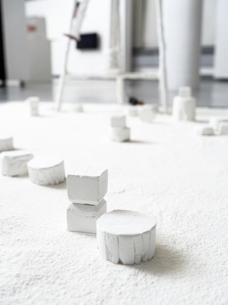 detail of floor sculpture with plaster pieces placed on a flour ground surface 