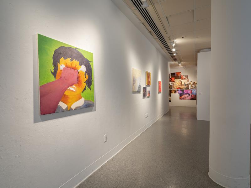 installation image of multiple paintings and a photo collage in a gallery