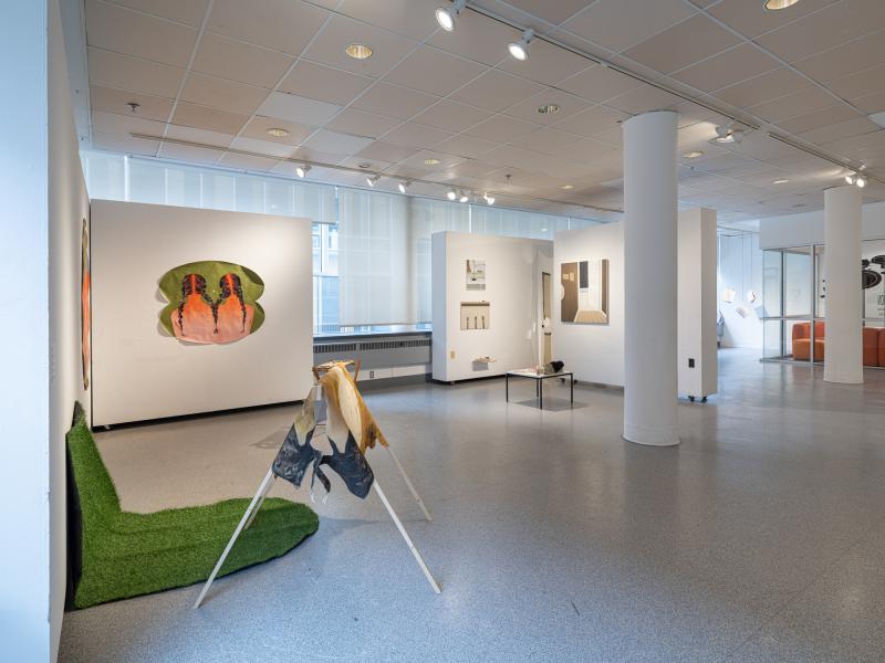 installation image of multiple floor pieces and paintings in a gallery 
