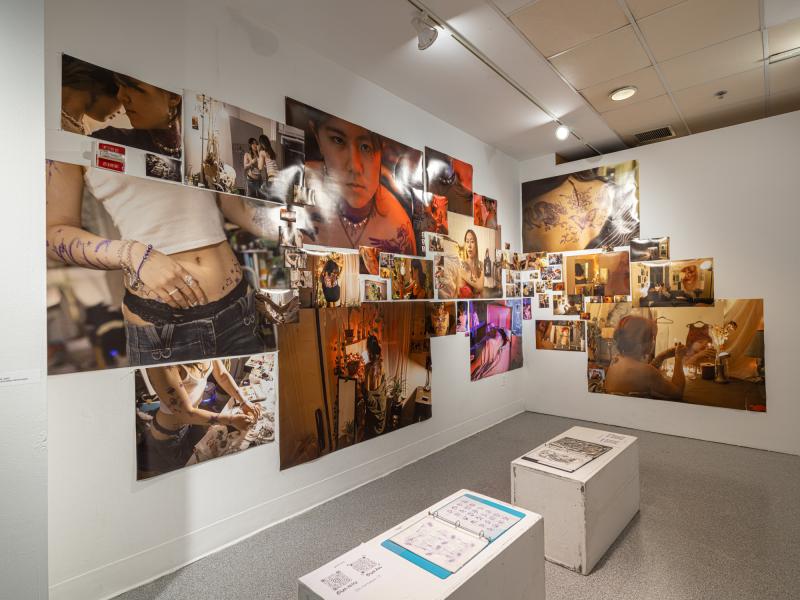 installation image of a large photo collage and pedestals in a gallery