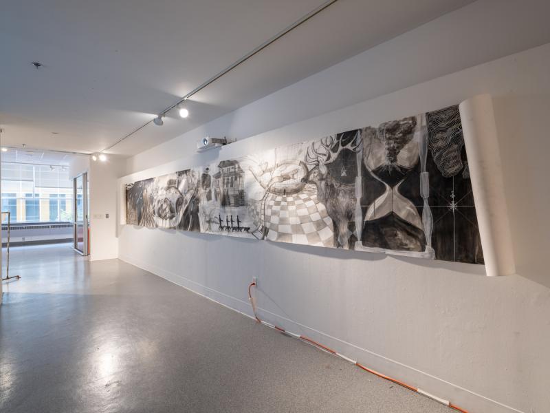 installation image of a large horizontal mixed media drawing on paper