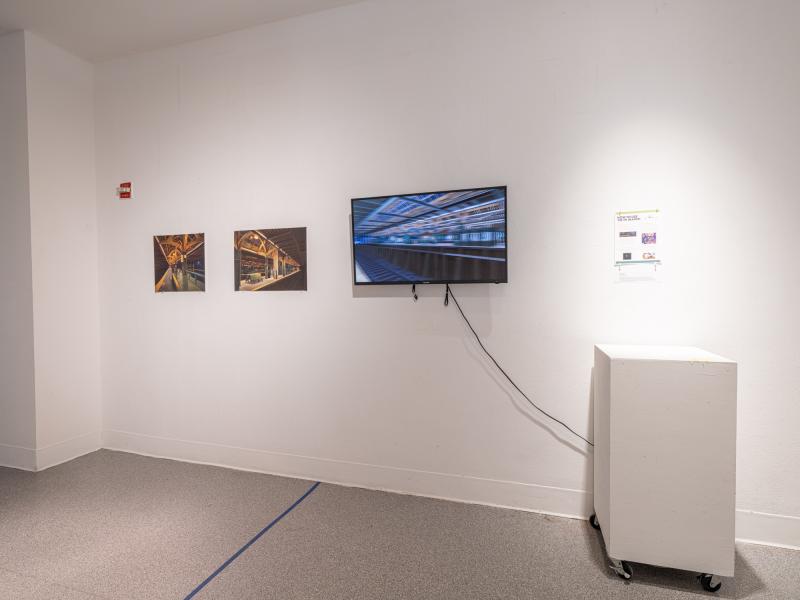 wall installation with a monitor and two prints 