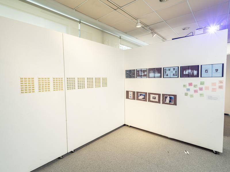 wall installation of printed material and photographs
