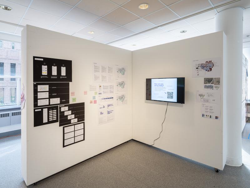 wall installation of multiple diagrams, graphics, and video display