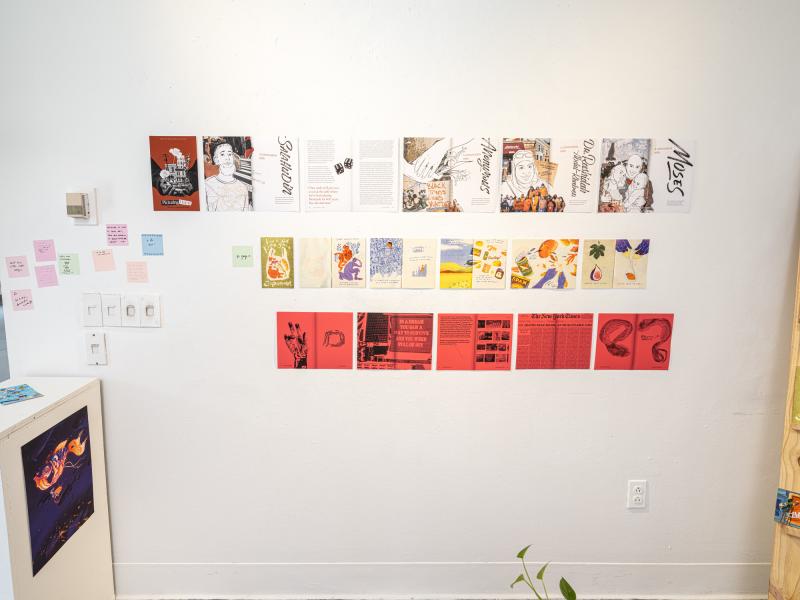 multiple printed materials and diagrams installed on gallery wall