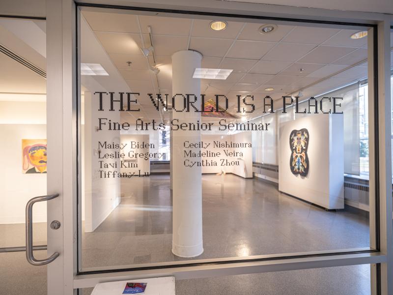 title of exhibition and names of artists installed on glass gallery entrance wall in vinyl