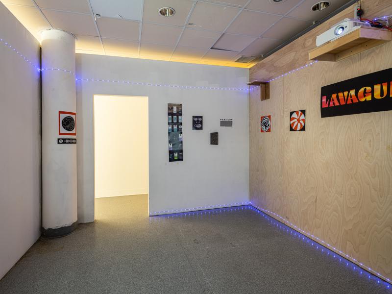 installation of posters and video projection in a dark interior