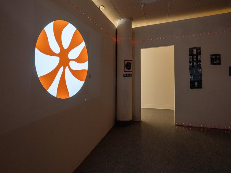 installation of posters and video projection in a dark interior