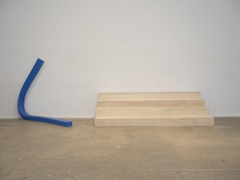 blue latex floor sculpture to the left with wooden stairs floor sculpture to the right