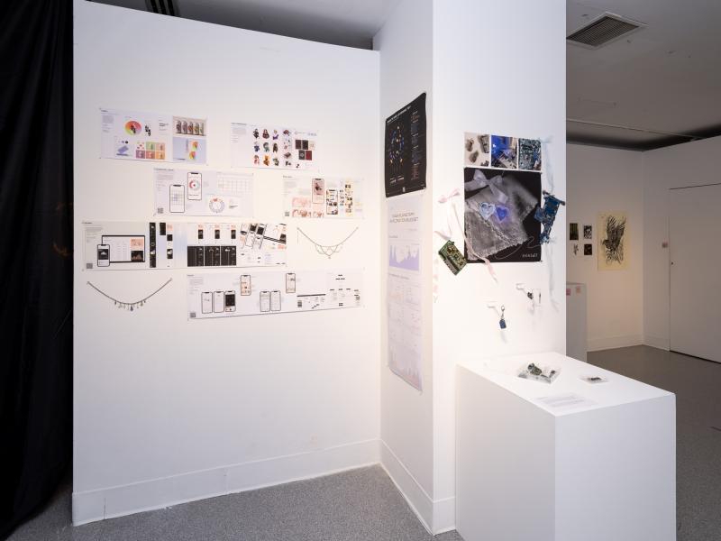 wall installation using multiple diagrams, drawings, and samples displayed on a pedestal