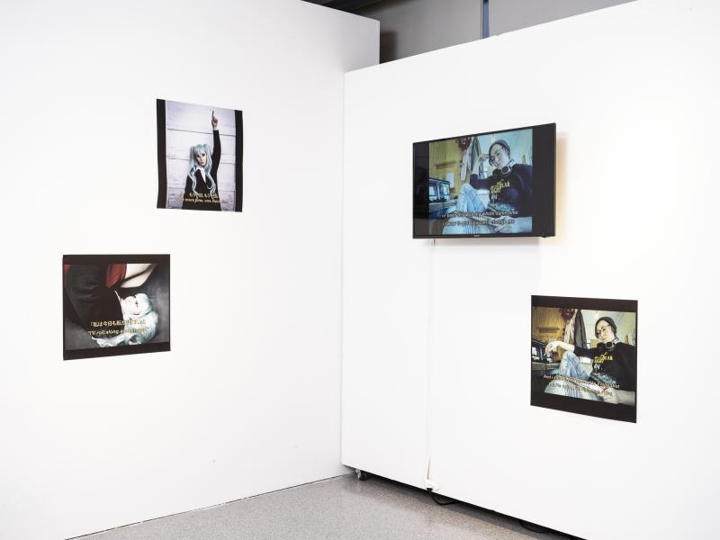 installation using multiple wall mounted video monitors and photographs
