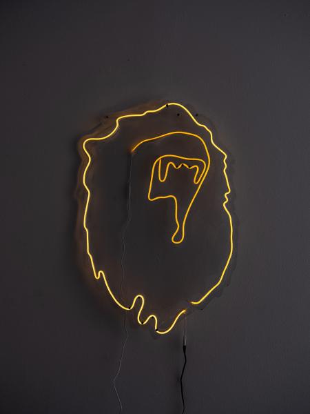 installation of yellow neon sign in a dark space