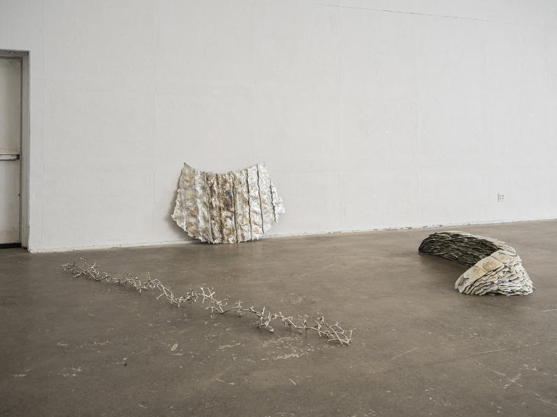 installation image of three pewter floor sculptures