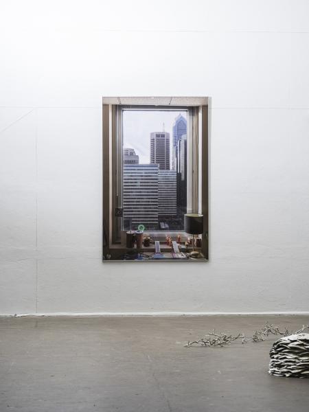 large wall hung photograph with pewter sculptures in the foreground