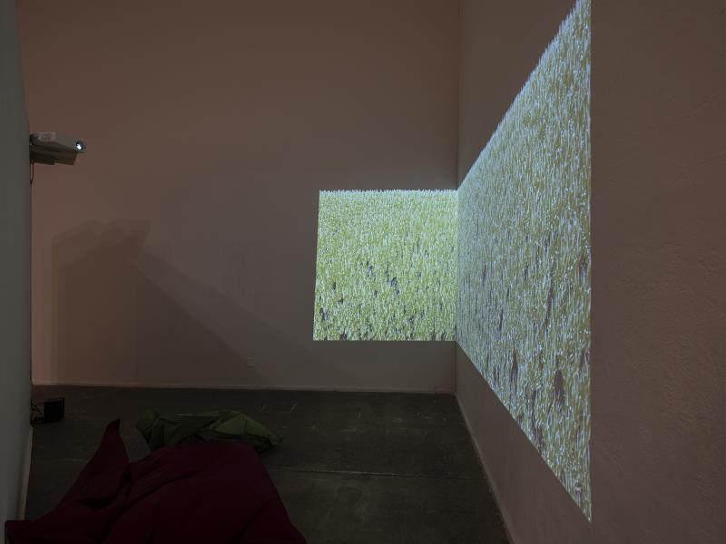 dual image projection displayed in the corner of two walls with beanbag seating