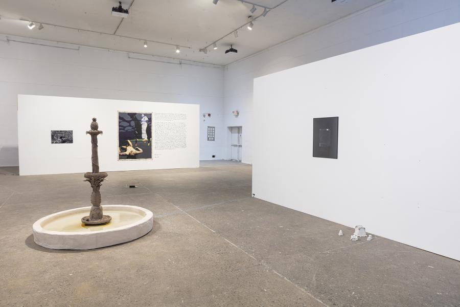 installation image of multiple pieces including a fountain sculpture, photography, and paintings 