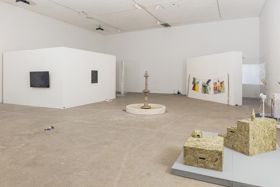 installation image of multiple sculptures, video monitor, paintings and projection
