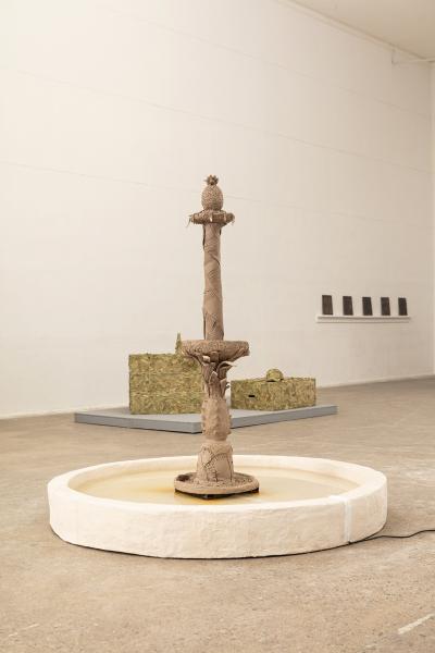 Image of fountain floor sculpture with other artworks in the background