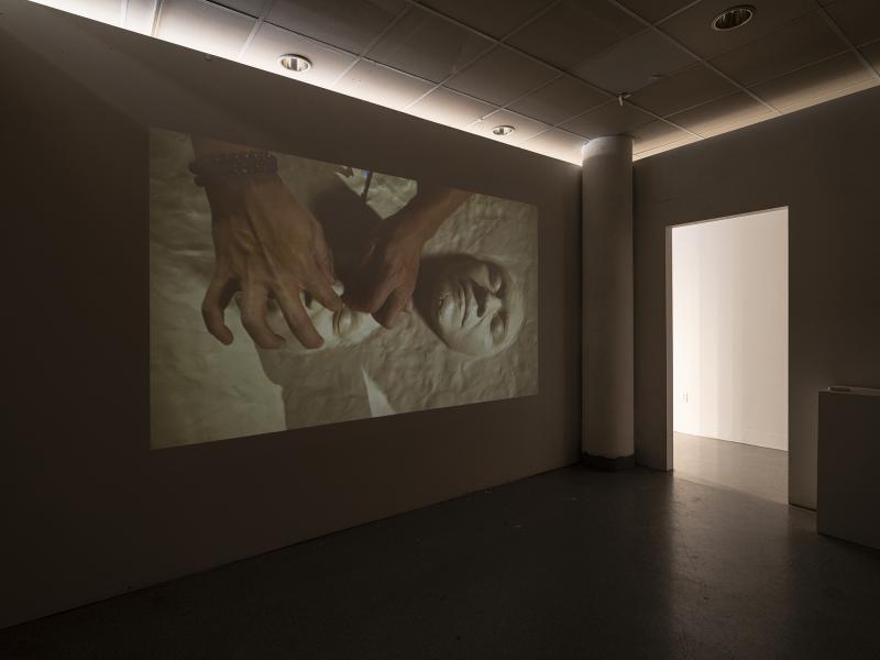 projected video installation in a darkened gallery space 