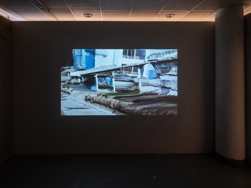 projected video artwork in a darkened gallery space