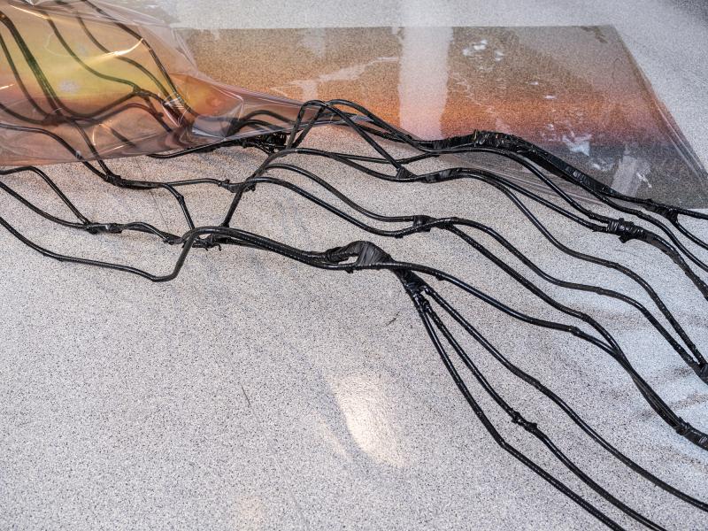 detail of a mixed media sculpture installed on a gallery floor