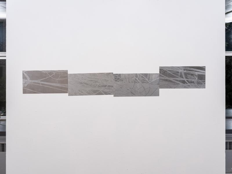 installation image of four printed works on aluminum 