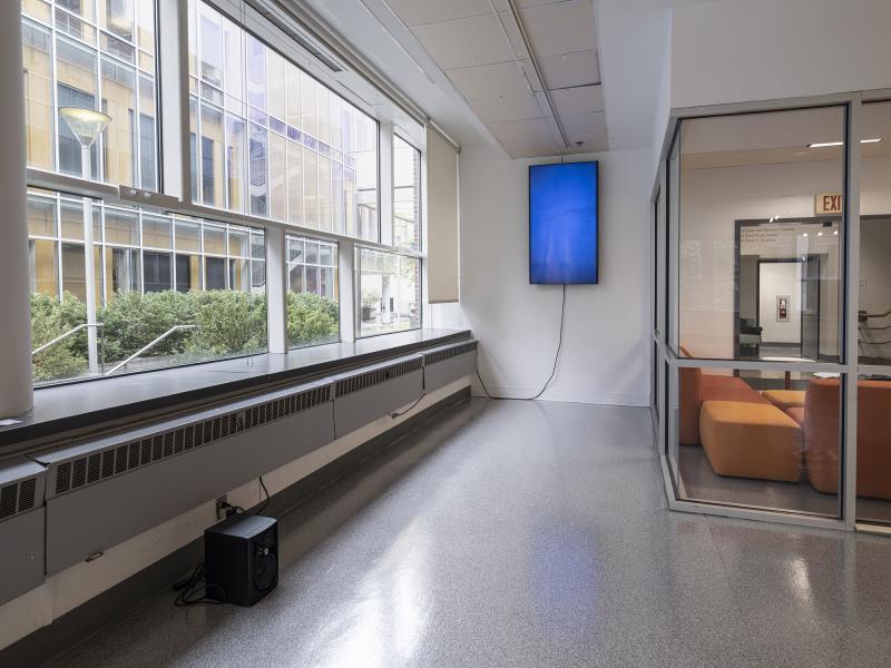 image of a speaker installed on the floor and a video monitor hanging from a gallery wall