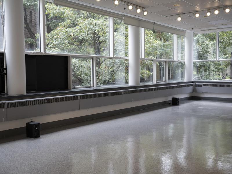 installation images of two small speakers installed on the floor of a gallery