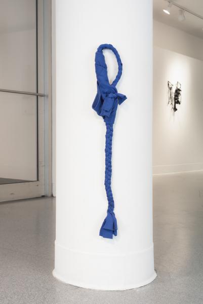 mixed media and fabric artwork installed on a gallery column