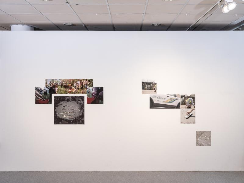multiple photographic works installed on a gallery wall