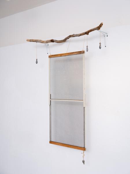 mixed media sculpture installed on a gallery wall