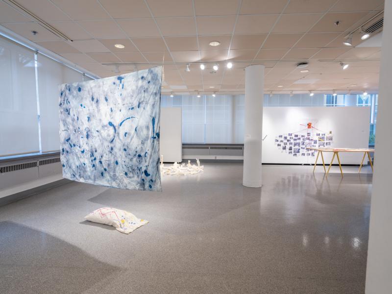 sculpture installation using a suspended painted sheet and pillow in a gallery setting