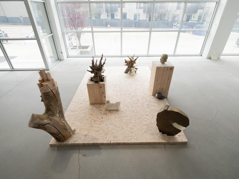 multiple sculptural pieces installed on the gallery floor