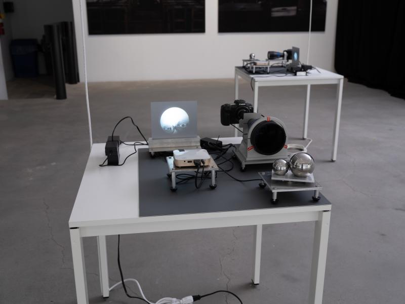 installation image of two small scale projections and cameras on two tables