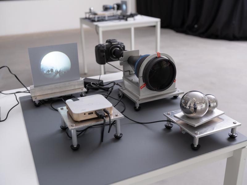 installation image of a small scale projection and camera on a table