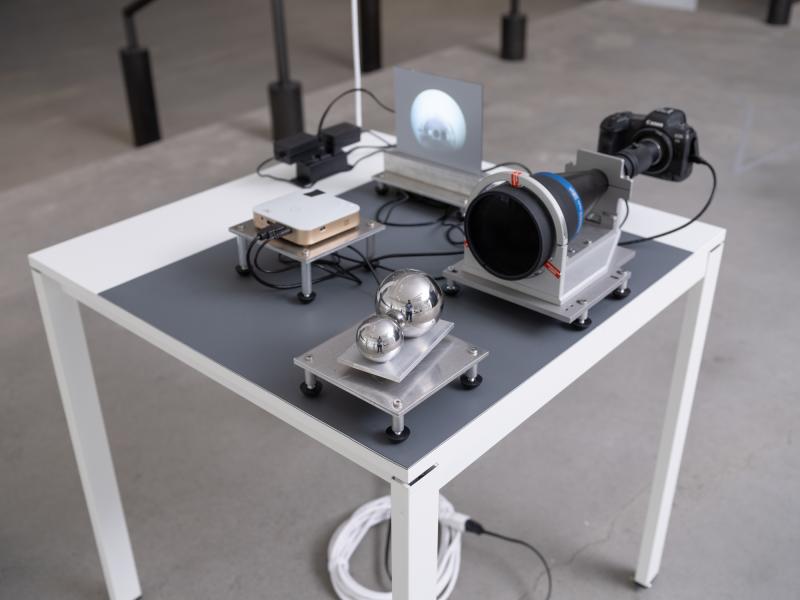 installation image of a small scale projection and camera on a table