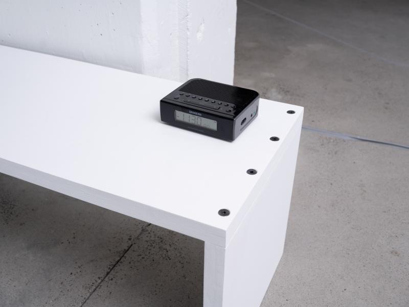 image of an installation using a radio on a gallery bench 