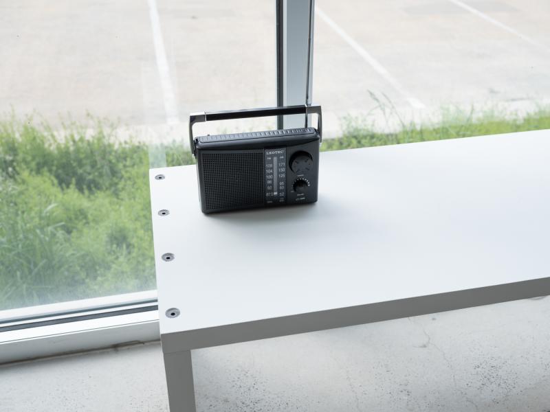 image of an installation using a radio on a gallery bench 