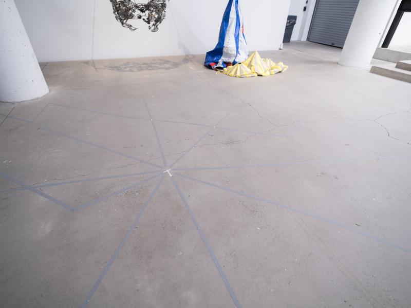 image of a large installation using strips of tape on the floor of a gallery