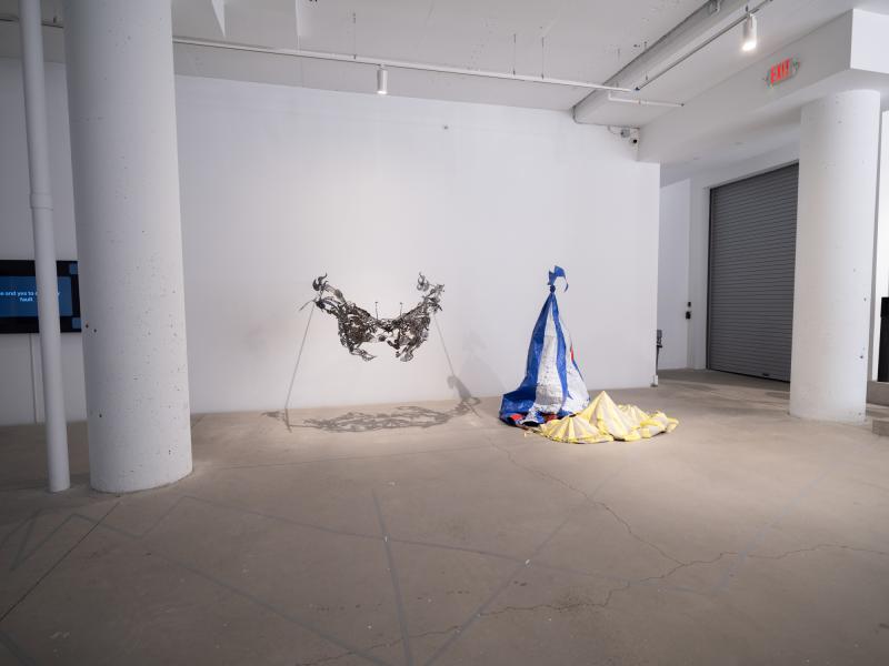 image of a wall hung sculpture and a floor sculpture installed in a gallery