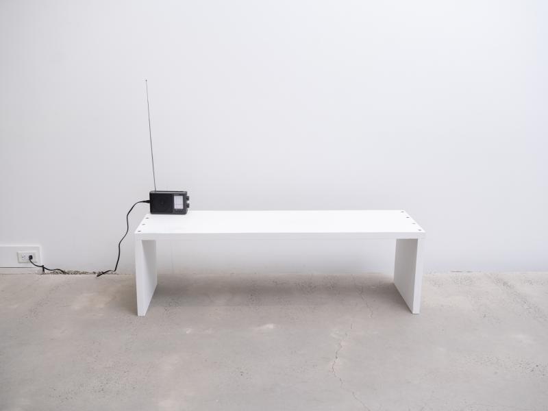 image of an installation using a radio on a gallery bench 