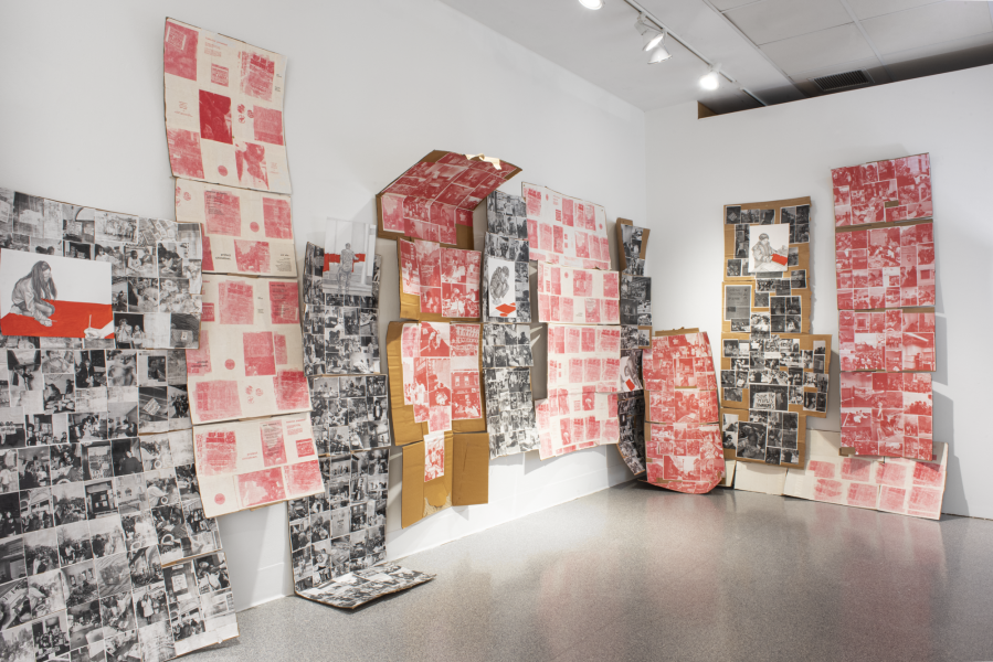 large installation of prints and photographs mounted on cardboard