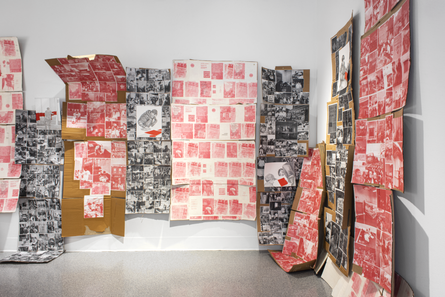 large installation of prints and photographs mounted on cardboard