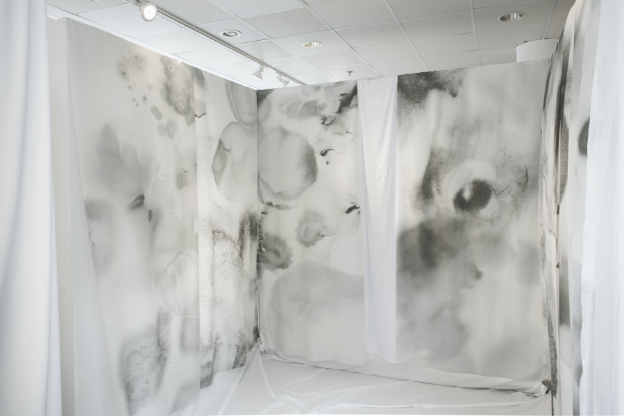 large installation of drawings on fabric installed in a corner