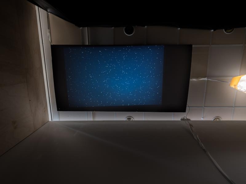 overhead image of a projection screen hanging from the ceiling