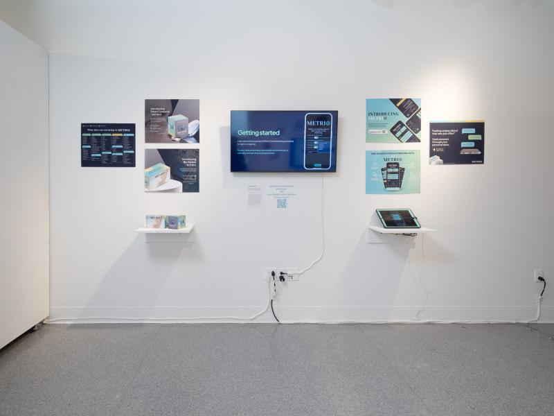 installation image of multiple graphics, monitor, cell phone, and tablet installed on a wall