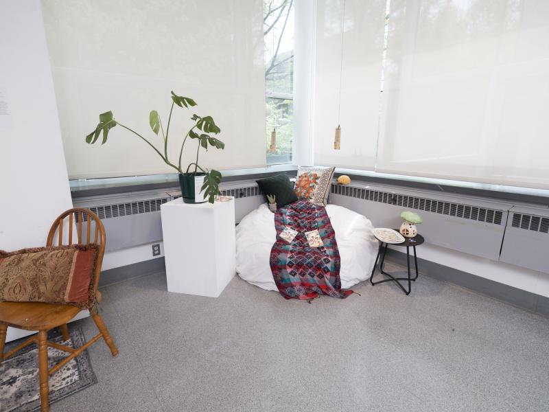 installation image of multiple items including a bean bag, side table, and a plant on a pedestal