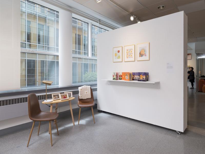 installation image of books and posters on display and reading chairs