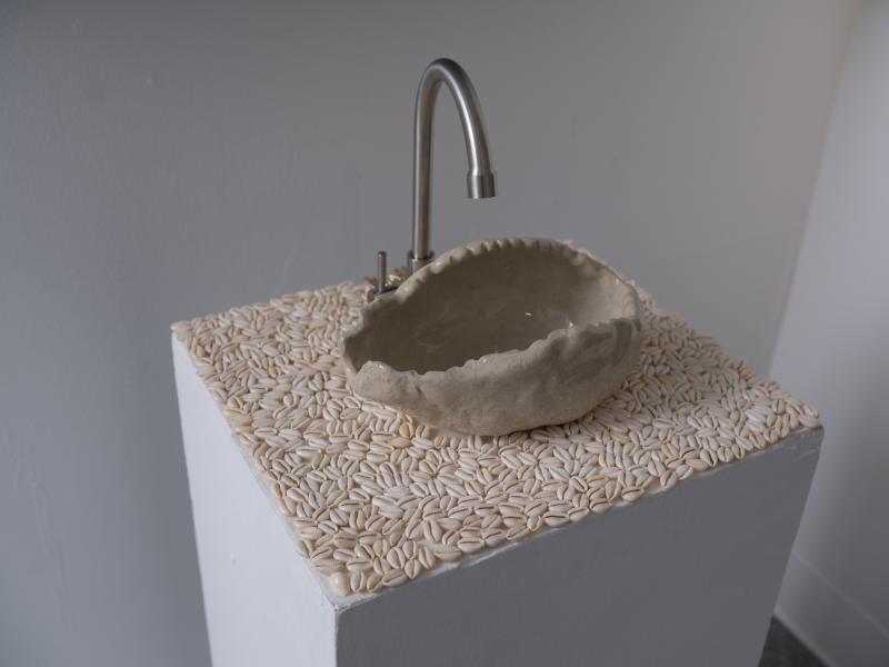 detail image of a sink and countertop using ceramics and shells